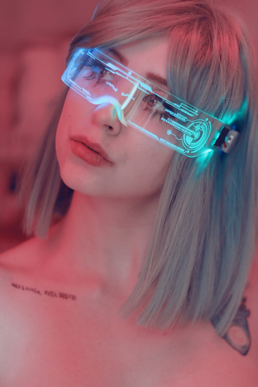 young woman with tattoos wearing futuristic glasses